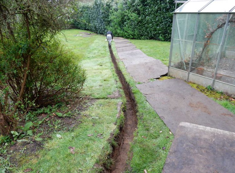 Driveway Drainage Ottershaw, Surrey - Linear drainage with cast iron gratings were proposed here to help prevent the constant threat of flooding from run off from the road. Water was diverted through large diamater pipe work and land drainage finaly being dispersed at the bottom of the garden. Garden Drainage - MDB Landscapes