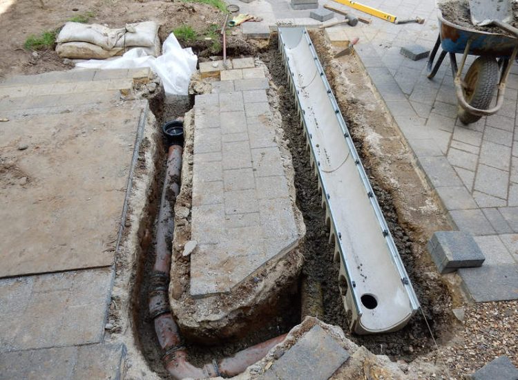 Driveway Drainage Ottershaw, Surrey - Linear drainage with cast iron gratings were proposed here to help prevent the constant threat of flooding from run off from the road. Water was diverted through large diamater pipe work and land drainage finaly being dispersed at the bottom of the garden. Garden Drainage - MDB Landscapes