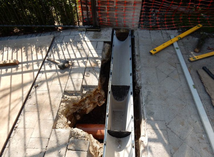 Driveway Drainage Ottershaw, Surrey - Linear drainage with cast iron gratings were proposed here to help prevent the constant threat of flooding from run off from the road. Water was diverted through large diamater pipe work and land drainage finaly being dispersed at the bottom of the garden. Garden Drainage - MDB Landscapes