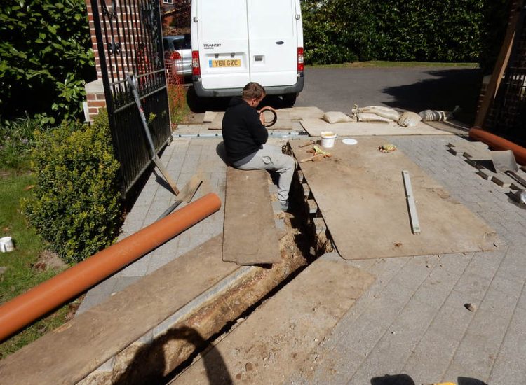Driveway Drainage Ottershaw, Surrey - Linear drainage with cast iron gratings were proposed here to help prevent the constant threat of flooding from run off from the road. Water was diverted through large diamater pipe work and land drainage finaly being dispersed at the bottom of the garden. Garden Drainage - MDB Landscapes
