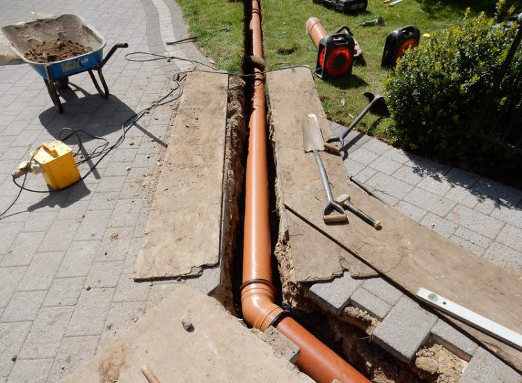 Driveway Drainage Ottershaw, Surrey - Linear drainage with cast iron gratings were proposed here to help prevent the constant threat of flooding from run off from the road. Water was diverted through large diamater pipe work and land drainage finaly being dispersed at the bottom of the garden. Garden Drainage - MDB Landscapes