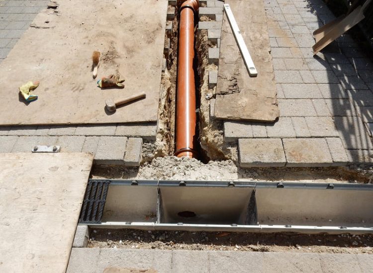 Driveway Drainage Ottershaw, Surrey - Linear drainage with cast iron gratings were proposed here to help prevent the constant threat of flooding from run off from the road. Water was diverted through large diamater pipe work and land drainage finaly being dispersed at the bottom of the garden. Garden Drainage - MDB Landscapes