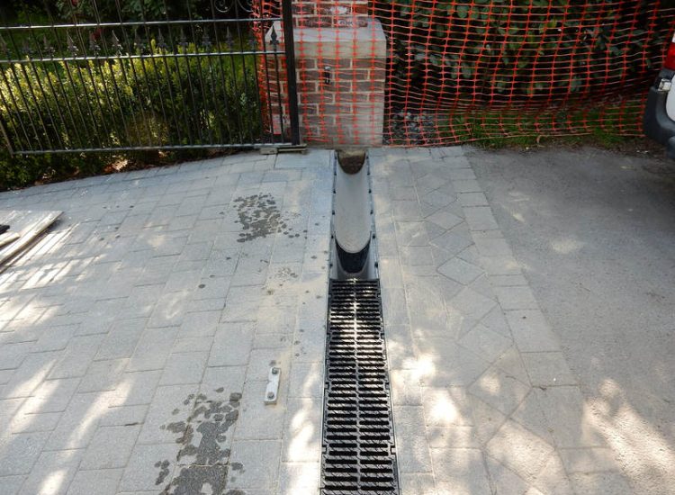 Driveway Drainage Ottershaw, Surrey - Linear drainage with cast iron gratings were proposed here to help prevent the constant threat of flooding from run off from the road. Water was diverted through large diamater pipe work and land drainage finaly being dispersed at the bottom of the garden. Garden Drainage - MDB Landscapes