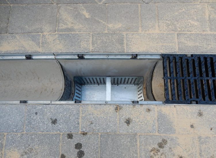 Driveway Drainage Ottershaw, Surrey - Linear drainage with cast iron gratings were proposed here to help prevent the constant threat of flooding from run off from the road. Water was diverted through large diamater pipe work and land drainage finaly being dispersed at the bottom of the garden. Garden Drainage - MDB Landscapes