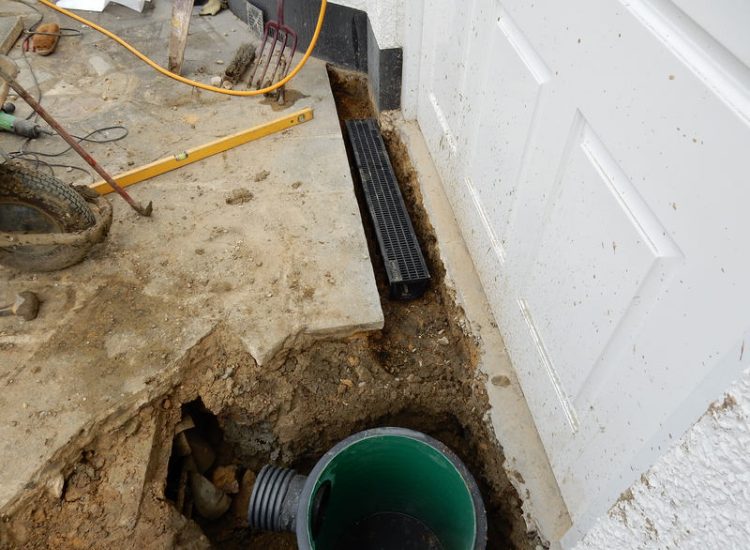Driveway Drainage Ewell, Epson, Surrey - Constant flooding of a garage created an interesting requirement of how to manage and disperse the water. Our proposal was to install a new sump and pump with adjoining linear surface drainage. Collected water was then pumped over the garage to finally disperse into a rear garden outlet. Garden Drainage - MDB Landscapes