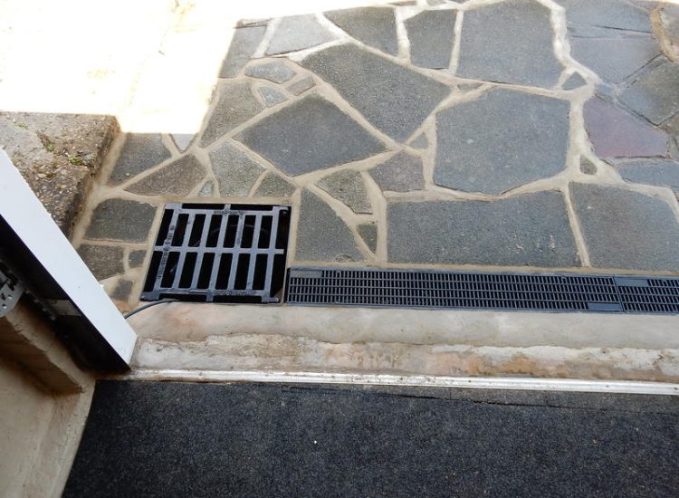 Driveway Drainage Ewell, Epson, Surrey - Constant flooding of a garage created an interesting requirement of how to manage and disperse the water. Our proposal was to install a new sump and pump with adjoining linear surface drainage. Collected water was then pumped over the garage to finally disperse into a rear garden outlet. Garden Drainage - MDB Landscapes