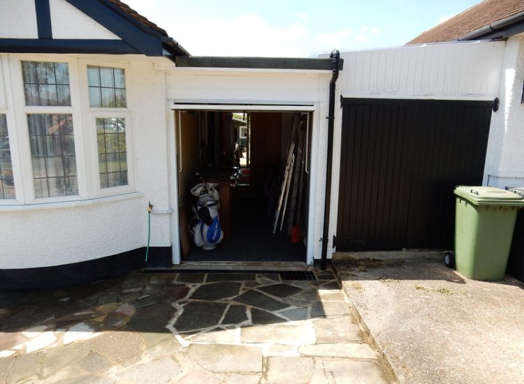 Driveway Drainage Ewell, Epson, Surrey - Constant flooding of a garage created an interesting requirement of how to manage and disperse the water. Our proposal was to install a new sump and pump with adjoining linear surface drainage. Collected water was then pumped over the garage to finally disperse into a rear garden outlet. Garden Drainage - MDB Landscapes