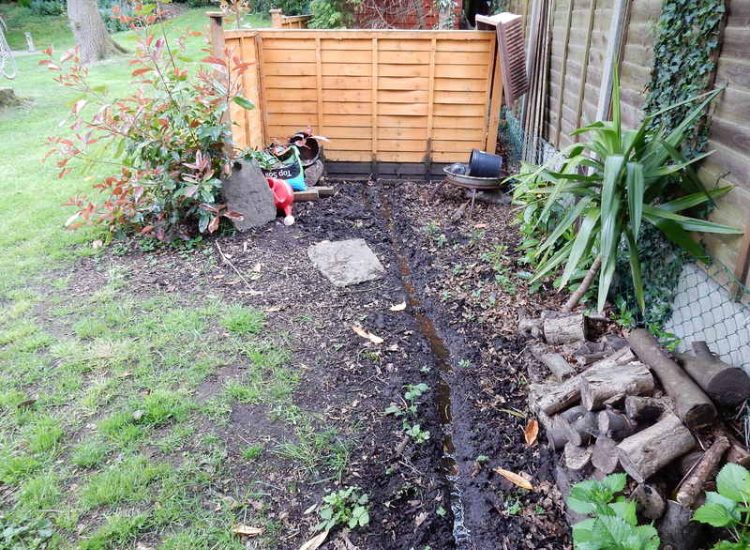 Garden Drainage Farnham, Surrey - A constant flow of in ground and over ground water was diverted to an existing culvert within the rear garden. Garden Drainage - MDB Landscapes