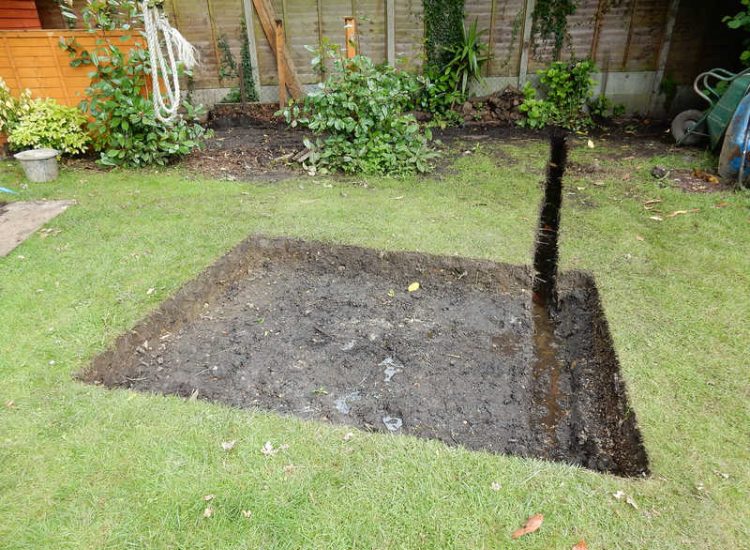 Garden Drainage Farnham, Surrey - A constant flow of in ground and over ground water was diverted to an existing culvert within the rear garden. Garden Drainage - MDB Landscapes