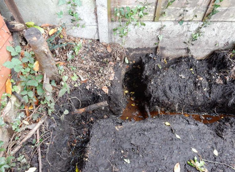 Garden Drainage Farnham, Surrey - A constant flow of in ground and over ground water was diverted to an existing culvert within the rear garden. Garden Drainage - MDB Landscapes