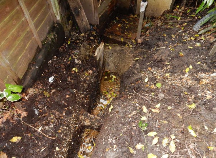 Garden Drainage Farnham, Surrey - A constant flow of in ground and over ground water was diverted to an existing culvert within the rear garden. Garden Drainage - MDB Landscapes