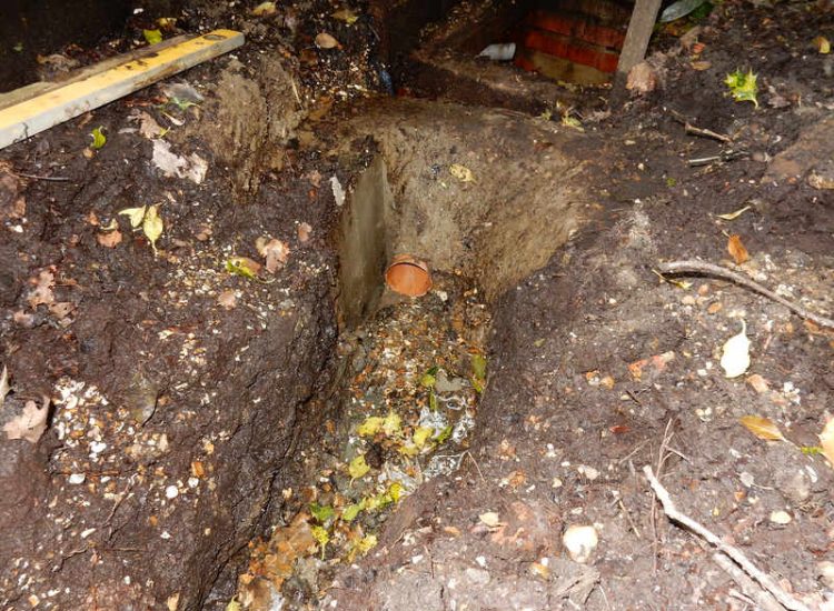 Garden Drainage Farnham, Surrey - A constant flow of in ground and over ground water was diverted to an existing culvert within the rear garden. Garden Drainage - MDB Landscapes