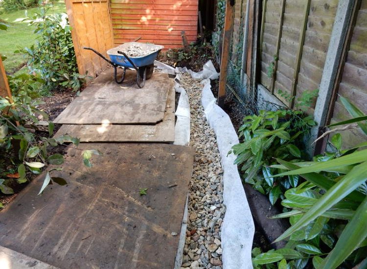 Garden Drainage Farnham, Surrey - A constant flow of in ground and over ground water was diverted to an existing culvert within the rear garden. Garden Drainage - MDB Landscapes
