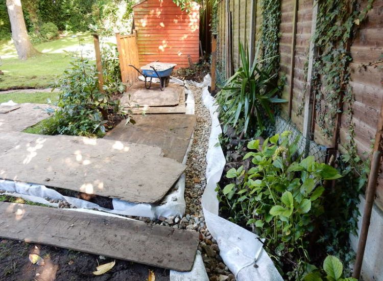 Garden Drainage Farnham, Surrey - A constant flow of in ground and over ground water was diverted to an existing culvert within the rear garden. Garden Drainage - MDB Landscapes