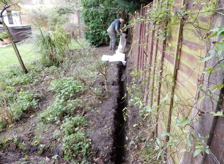 Garden Drainage Great Bookham, Leatherhead, Surrey - To protect from intermittent flooding of thier garden and to protect thier property we were approached by the client to help resolve the ongoing issues. A perimeter drainage run was installed using 160mm diameter land drain pipe leading to the final outlet point via a silt trap. Garden Drainage - MDB Landscapes