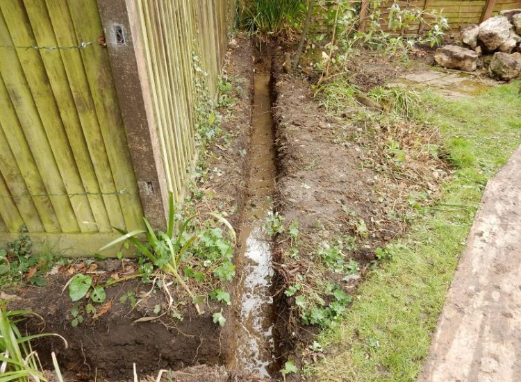 Garden Drainage Great Bookham, Leatherhead, Surrey - To protect from intermittent flooding of thier garden and to protect thier property we were approached by the client to help resolve the ongoing issues. A perimeter drainage run was installed using 160mm diameter land drain pipe leading to the final outlet point via a silt trap. Garden Drainage - MDB Landscapes