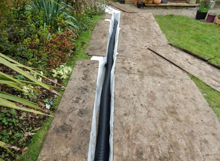 Garden Drainage Great Bookham, Leatherhead, Surrey - To protect from intermittent flooding of thier garden and to protect thier property we were approached by the client to help resolve the ongoing issues. A perimeter drainage run was installed using 160mm diameter land drain pipe leading to the final outlet point via a silt trap. Garden Drainage - MDB Landscapes