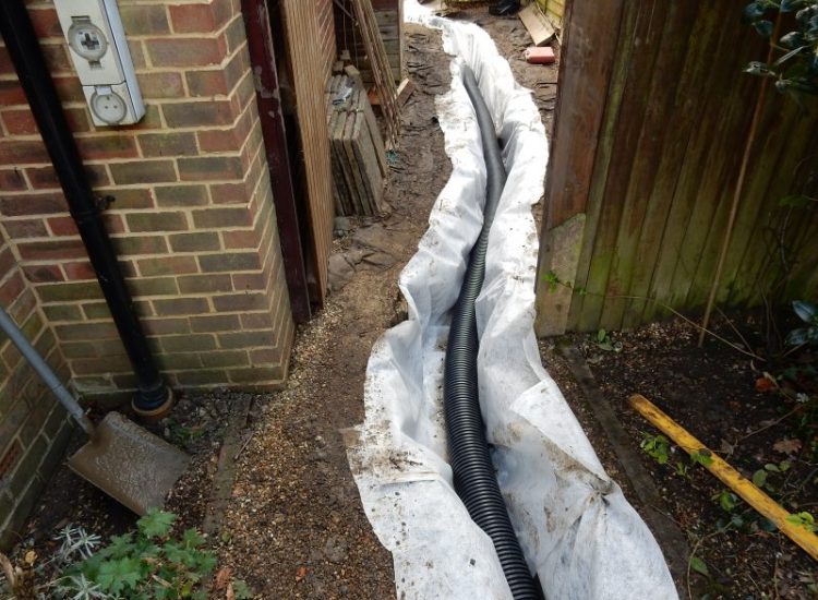 Garden Drainage Great Bookham, Leatherhead, Surrey - To protect from intermittent flooding of thier garden and to protect thier property we were approached by the client to help resolve the ongoing issues. A perimeter drainage run was installed using 160mm diameter land drain pipe leading to the final outlet point via a silt trap. Garden Drainage - MDB Landscapes