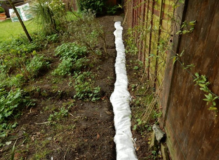 Garden Drainage Great Bookham, Leatherhead, Surrey - To protect from intermittent flooding of thier garden and to protect thier property we were approached by the client to help resolve the ongoing issues. A perimeter drainage run was installed using 160mm diameter land drain pipe leading to the final outlet point via a silt trap. Garden Drainage - MDB Landscapes