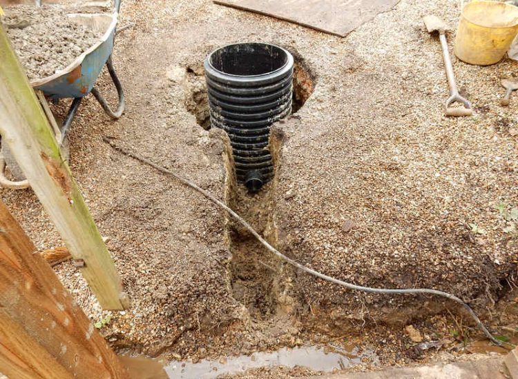 Garden Drainage Lovedean, Hampshire - The installation by the client of a small retained terrace area restricted and diverted the natural flow of water running through the rear garden. The now trapped water was diverted via a new sump and pump and finally discharging into a storm water drain. Garden Drainage - MDB Landscapes