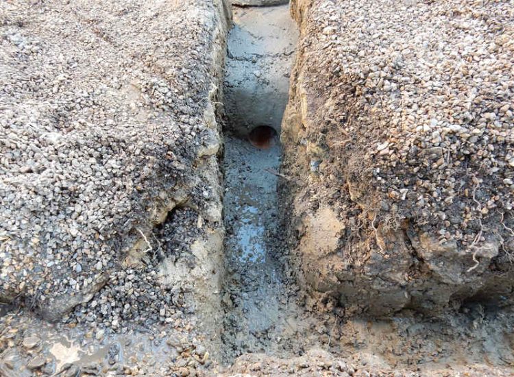 Garden Drainage Lovedean, Hampshire - The installation by the client of a small retained terrace area restricted and diverted the natural flow of water running through the rear garden. The now trapped water was diverted via a new sump and pump and finally discharging into a storm water drain. Garden Drainage - MDB Landscapes