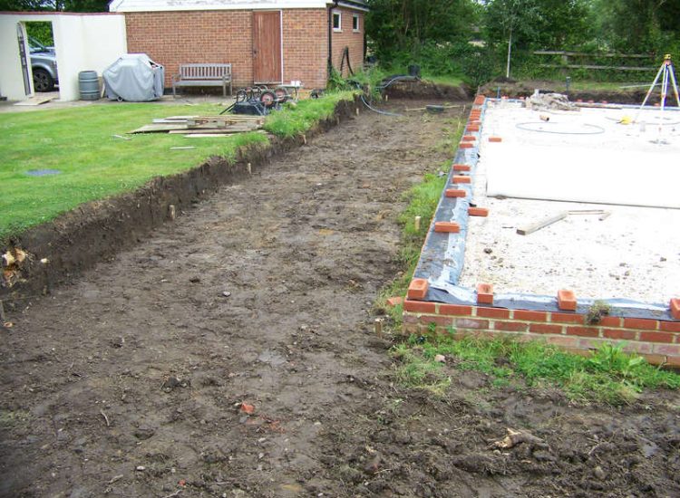 Drainage Layers and Lawn Drainage, Chobham, Surrey - The remit here was to install drainage around a new oak barn build prior to installation and for future drainage safe guards. Extensive lawn areas required land drainage to improve upon consitantly water logged areas of the garden. Garden Drainage - MDB Landscapes