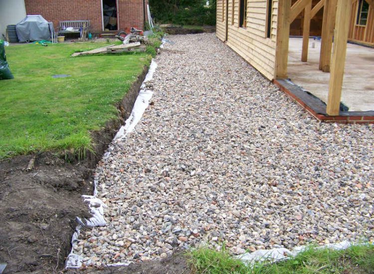 Drainage Layers and Lawn Drainage, Chobham, Surrey - The remit here was to install drainage around a new oak barn build prior to installation and for future drainage safe guards. Extensive lawn areas required land drainage to improve upon consitantly water logged areas of the garden. Garden Drainage - MDB Landscapes