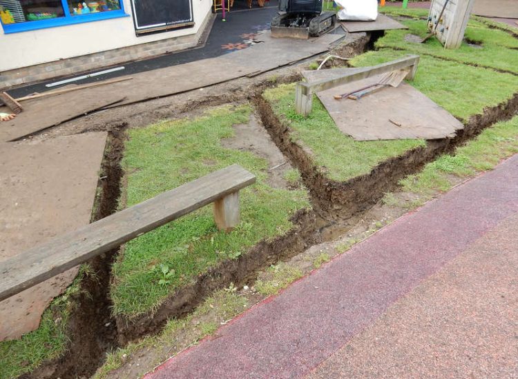 Play Ground Drainage Farnham, Surrey - Water ingress from higher ground created almost unusable play areas for the children in this day nursery. Drainage was installed prior to other contractors laying artificial grass. Garden drainage - MDB Landscapes