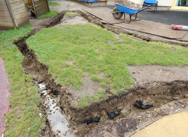 Play Ground Drainage Farnham, Surrey - Water ingress from higher ground created almost unusable play areas for the children in this day nursery. Drainage was installed prior to other contractors laying artificial grass. Garden drainage - MDB Landscapes