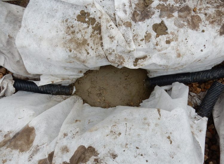 Play Ground Drainage Farnham, Surrey - Water ingress from higher ground created almost unusable play areas for the children in this day nursery. Drainage was installed prior to other contractors laying artificial grass. Garden drainage - MDB Landscapes
