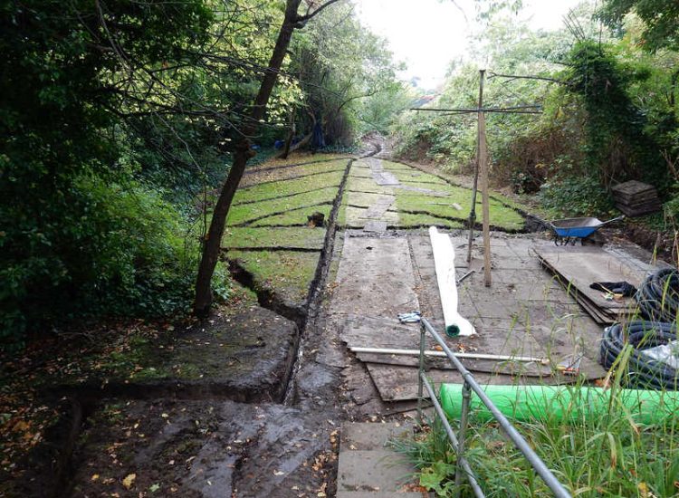 Residential Flats Lawn Drainage London, NW6 - Communal garden areas were constantly flooding leaving unusable and unmanageable saturated lawns. The gardens here were in two levels with both lawns requiring drainage. Extensive land drainage was installed with the oulet point for the drainage within the lower grounds of the garden. Garden Drainage - MDB Landscapes