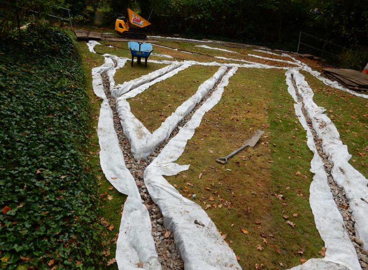 Residential Flats Lawn Drainage London, NW6 - Communal garden areas were constantly flooding leaving unusable and unmanageable saturated lawns. The gardens here were in two levels with both lawns requiring drainage. Extensive land drainage was installed with the oulet point for the drainage within the lower grounds of the garden. Garden Drainage - MDB Landscapes