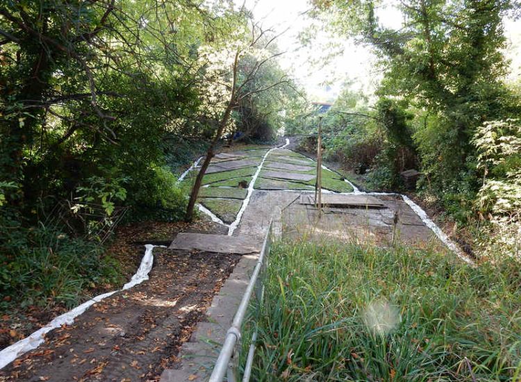 Residential Flats Lawn Drainage London, NW6 - Communal garden areas were constantly flooding leaving unusable and unmanageable saturated lawns. The gardens here were in two levels with both lawns requiring drainage. Extensive land drainage was installed with the oulet point for the drainage within the lower grounds of the garden. Garden Drainage - MDB Landscapes