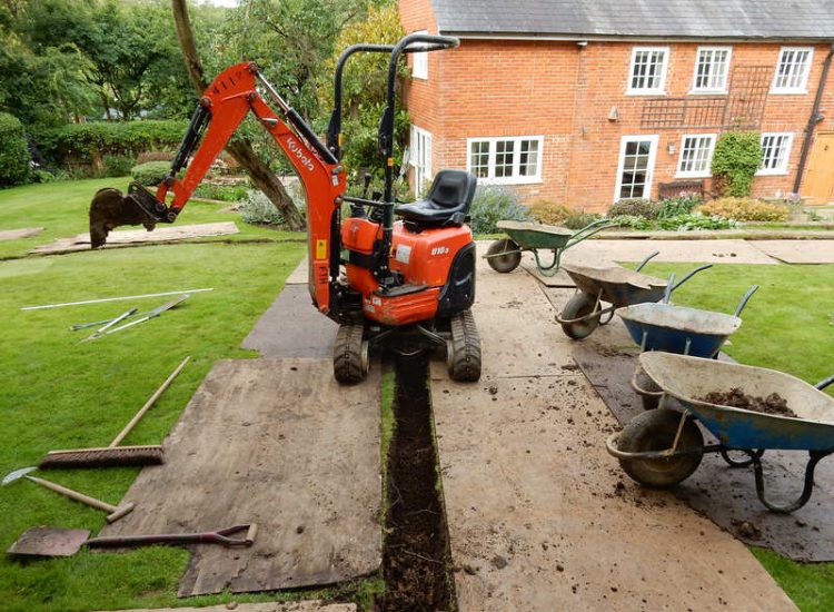 Lawn Drainage Crondall, Hampshire - A substantial lawn area suffering from water ingress from highr ground. Land drainage was installed with drainage trenches re-turfed. The outlet point here was lower ground within a wooded area. Garden Drainage - MDB Landscapes