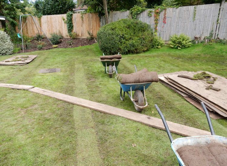 Lawn Drainage Crondall, Hampshire - A substantial lawn area suffering from water ingress from highr ground. Land drainage was installed with drainage trenches re-turfed. The outlet point here was lower ground within a wooded area. Garden Drainage - MDB Landscapes