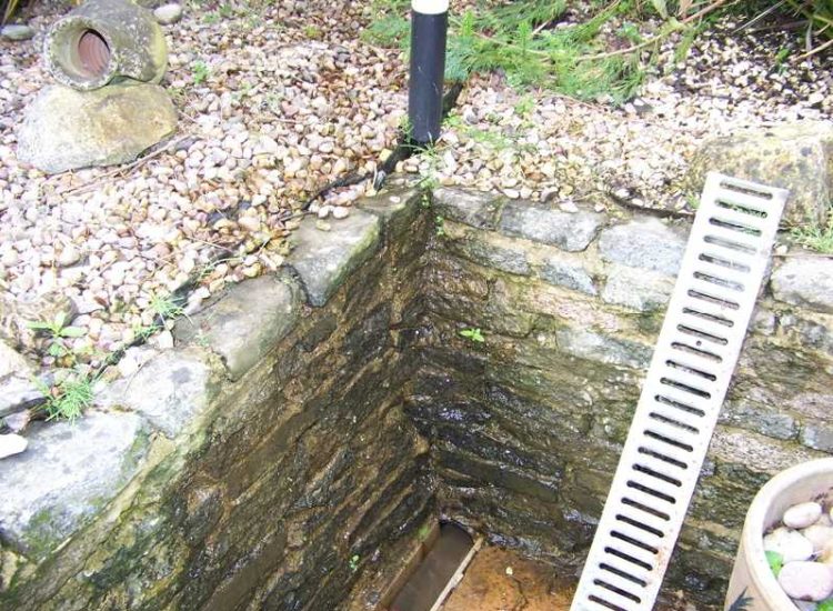 Garden and Lawn Drainage Farnham, Surrey - Drainage was proposed and installed to help capture and divert existing run off from a running brook causing issues with wet and boggy lawn areas. The water was dispersed via newly replaced drainage gullies connected to an existing outlet. Garden Drainage - MDB Landscapes