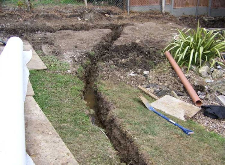 Garden and Lawn Drainage Farnham, Surrey - Drainage was proposed and installed to help capture and divert existing run off from a running brook causing issues with wet and boggy lawn areas. The water was dispersed via newly replaced drainage gullies connected to an existing outlet. Garden Drainage - MDB Landscapes