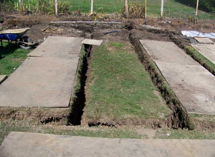 Garden and Lawn Drainage Farnham, Surrey - Drainage was proposed and installed to help capture and divert existing run off from a running brook causing issues with wet and boggy lawn areas. The water was dispersed via newly replaced drainage gullies connected to an existing outlet. Garden Drainage - MDB Landscapes