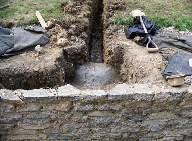 Garden and Lawn Drainage Farnham, Surrey - Drainage was proposed and installed to help capture and divert existing run off from a running brook causing issues with wet and boggy lawn areas. The water was dispersed via newly replaced drainage gullies connected to an existing outlet. Garden Drainage - MDB Landscapes