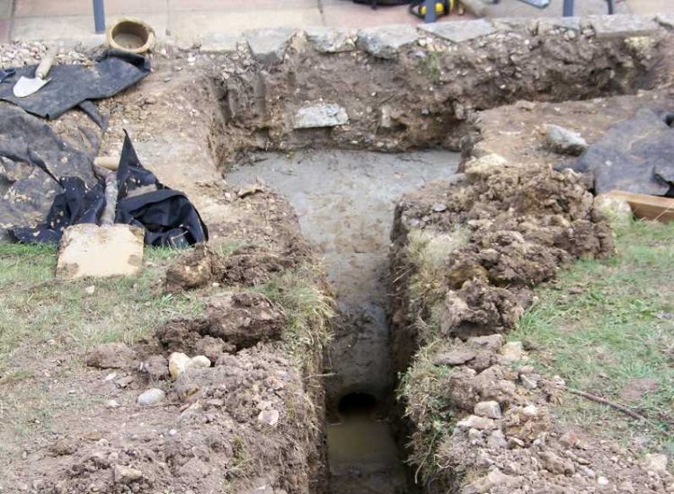 Garden and Lawn Drainage Farnham, Surrey - Drainage was proposed and installed to help capture and divert existing run off from a running brook causing issues with wet and boggy lawn areas. The water was dispersed via newly replaced drainage gullies connected to an existing outlet. Garden Drainage - MDB Landscapes