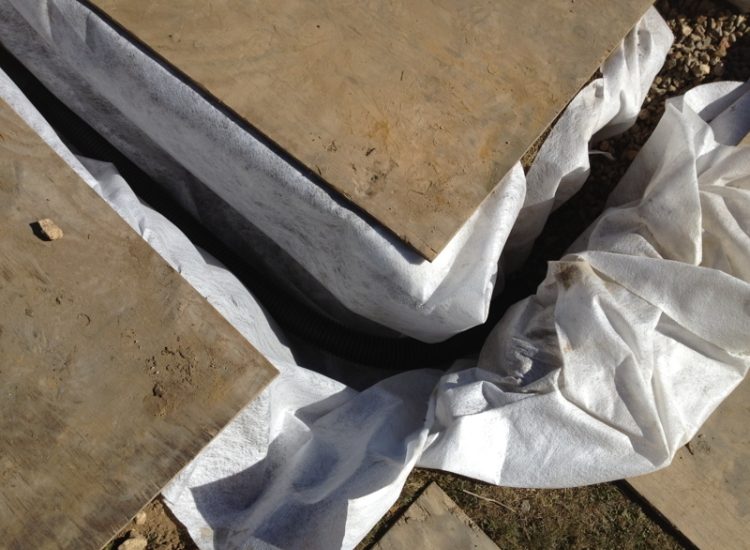 Garden and Lawn Drainage Farnham, Surrey - Drainage was proposed and installed to help capture and divert existing run off from a running brook causing issues with wet and boggy lawn areas. The water was dispersed via newly replaced drainage gullies connected to an existing outlet. Garden Drainage - MDB Landscapes