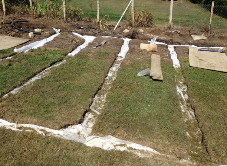 Garden and Lawn Drainage Farnham, Surrey - Drainage was proposed and installed to help capture and divert existing run off from a running brook causing issues with wet and boggy lawn areas. The water was dispersed via newly replaced drainage gullies connected to an existing outlet. Garden Drainage - MDB Landscapes