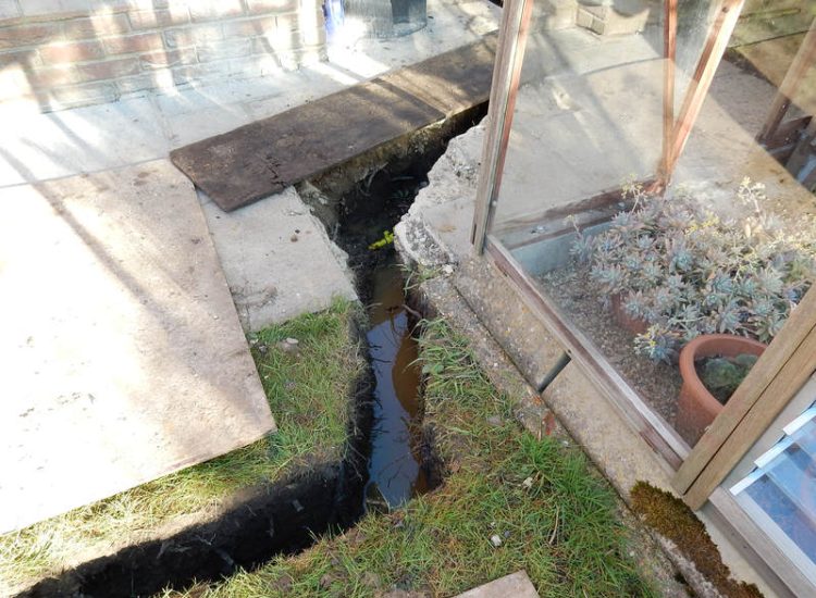 Garden Drainage Great Bookham, Leatherhead, Surrey - An ongoing issue with excessive water finding its way into the cellar of this clients property puting pressure on already installed sump pumps. Perimeter drainage was installed to catch and divert the flow of water helping to reduce the required constant use of the installed pumps. Garden Drainage - MDB Landscapes