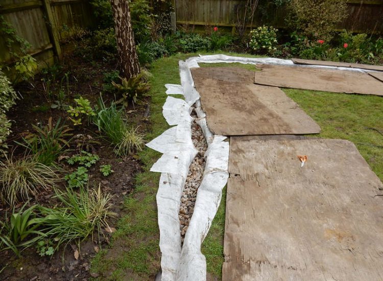 Garden Drainage Great Bookham, Leatherhead, Surrey - An ongoing issue with excessive water finding its way into the cellar of this clients property puting pressure on already installed sump pumps. Perimeter drainage was installed to catch and divert the flow of water helping to reduce the required constant use of the installed pumps. Garden Drainage - MDB Landscapes