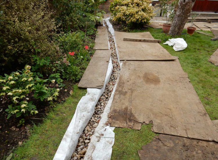 Garden Drainage Great Bookham, Leatherhead, Surrey - An ongoing issue with excessive water finding its way into the cellar of this clients property puting pressure on already installed sump pumps. Perimeter drainage was installed to catch and divert the flow of water helping to reduce the required constant use of the installed pumps. Garden Drainage - MDB Landscapes