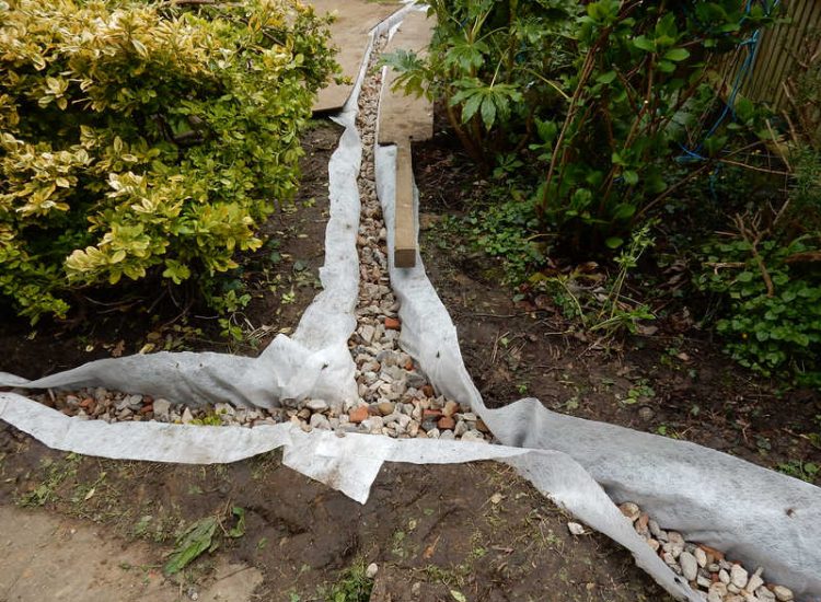 Garden Drainage Great Bookham, Leatherhead, Surrey - An ongoing issue with excessive water finding its way into the cellar of this clients property puting pressure on already installed sump pumps. Perimeter drainage was installed to catch and divert the flow of water helping to reduce the required constant use of the installed pumps. Garden Drainage - MDB Landscapes