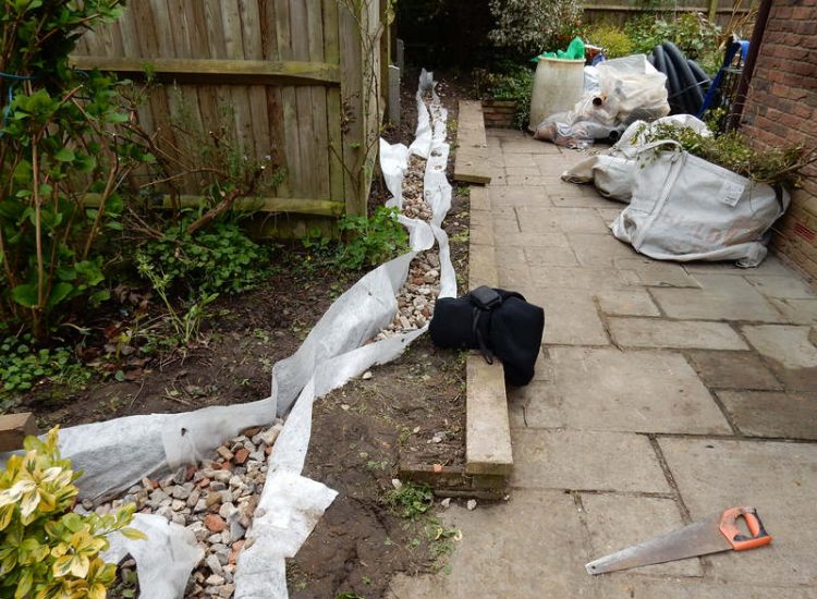 Garden Drainage Great Bookham, Leatherhead, Surrey - An ongoing issue with excessive water finding its way into the cellar of this clients property puting pressure on already installed sump pumps. Perimeter drainage was installed to catch and divert the flow of water helping to reduce the required constant use of the installed pumps. Garden Drainage - MDB Landscapes