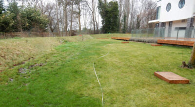 Lawn Drainage Hersham, Surrey - Building works had left an area of the garden in poor state, compacted with buried waste materials. There was also an added issue of Constant water ingress from an unknown source. Levels were reduced first, drainage installed using the river as an outlet source, topsoil spread and grass seeded on completion. Garden Drainage - MDB Landscapes