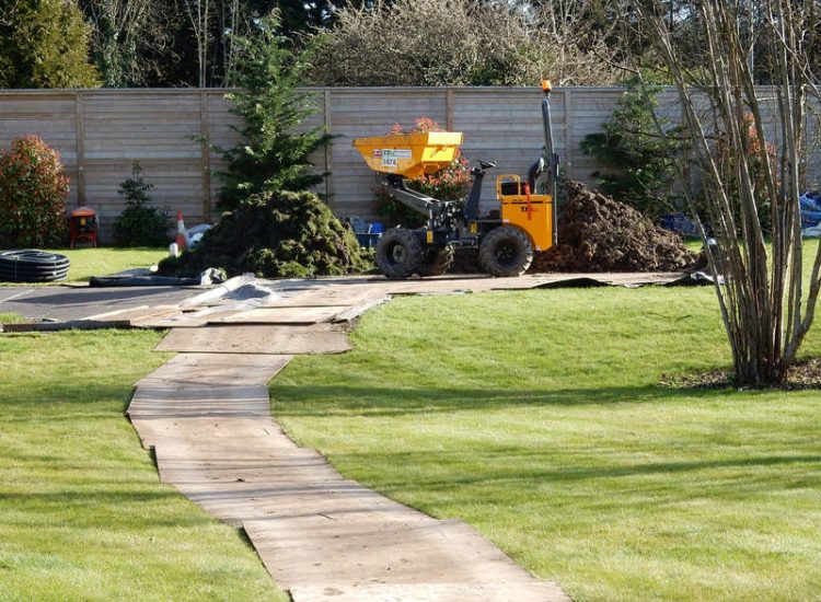 Lawn Drainage Hersham, Surrey - Building works had left an area of the garden in poor state, compacted with buried waste materials. There was also an added issue of Constant water ingress from an unknown source. Levels were reduced first, drainage installed using the river as an outlet source, topsoil spread and grass seeded on completion. Garden Drainage - MDB Landscapes