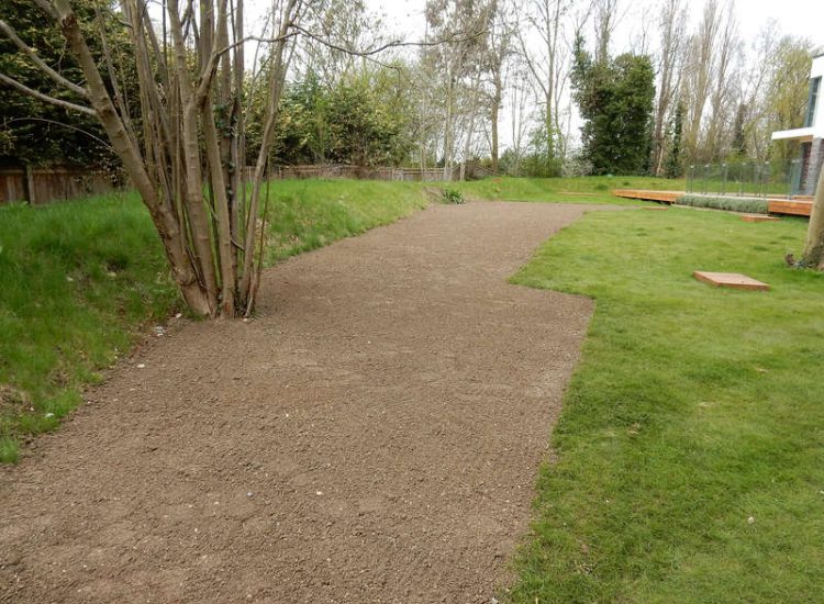 Lawn Drainage Hersham, Surrey - Building works had left an area of the garden in poor state, compacted with buried waste materials. There was also an added issue of Constant water ingress from an unknown source. Levels were reduced first, drainage installed using the river as an outlet source, topsoil spread and grass seeded on completion. Garden Drainage - MDB Landscapes